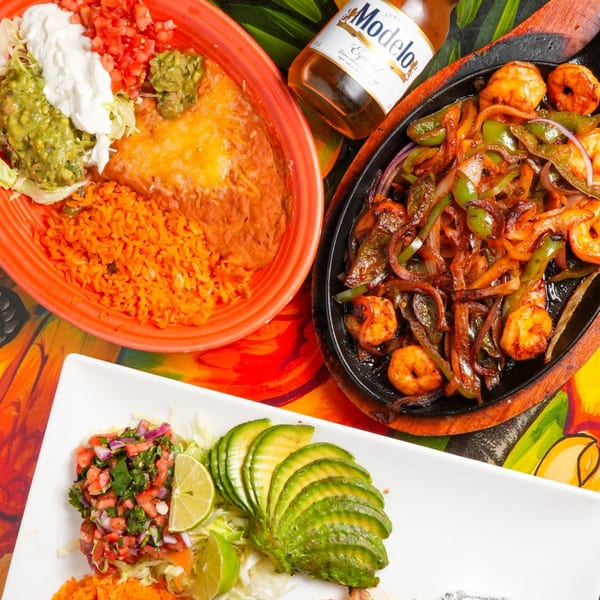 Los Magueyes Mexican Restaurant's shrimp fajitas, enchilada, rice, beans, and Modelo beer.