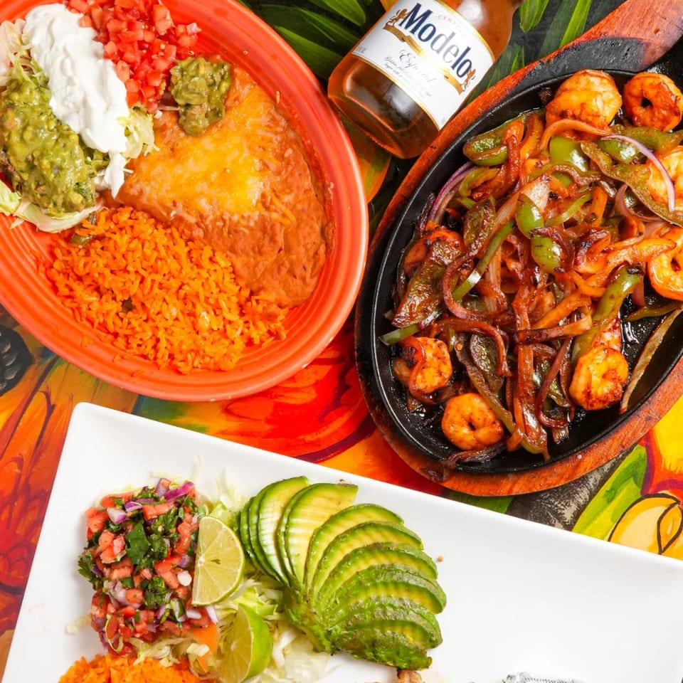 Los Magueyes Mexican Restaurant's shrimp fajitas, enchilada, rice, beans, and Modelo beer.